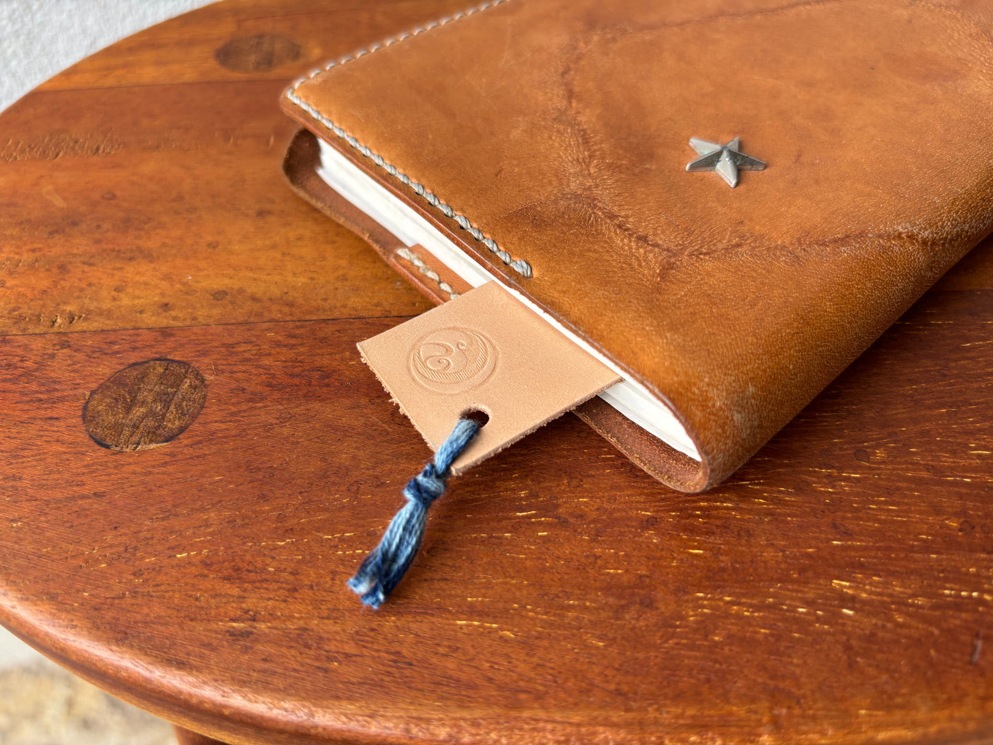 Leather bookmark tied with indigo-dyed thread